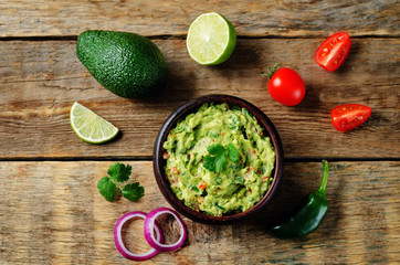 Wall Mural - Guacamole with flying corn chips and ingredients to prepare it