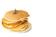Stack of pancakes isolated on white background with miniature figure of mountain biker on the top. Concept image for sport, travel, exploring, eating, breakfast, fastfood or restaurant.