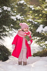 The child with flowers on the background of snowcovered spruce forest 9