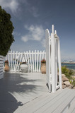 Fototapeta  - Bright white colored entrance into cafe by the sea