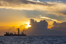 Machineries On Ship In Sea Against Cloudy Sky During Sunset