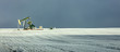 © Cavan Images - Panoramic view of pumpjack at oil industry on field against sky during winter