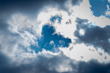 blue sky with white clouds. the rays of the sun make their way.