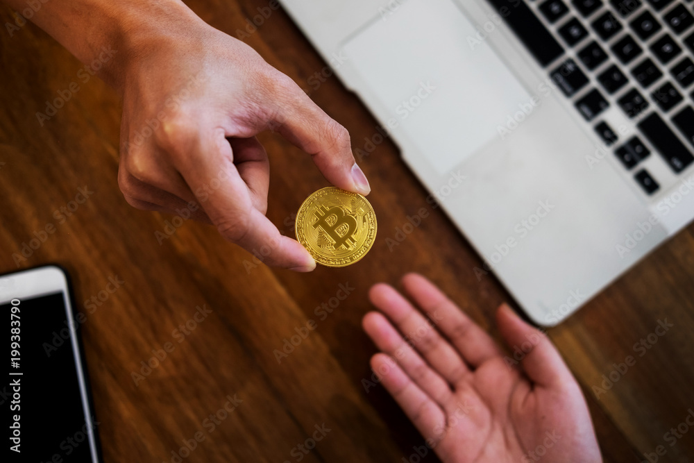 hand exchange golden metal Bitcoin crypto currency investment- symbolic block chain financial internet and technology.