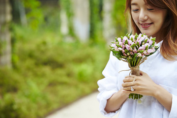 Korean girl holding flower bouquet