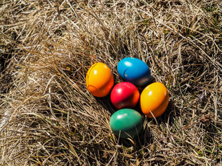 painted easter eggs laying in the grass on top of a mountain