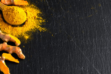 Fresh root and turmeric powder, indian spice, healthy seasoning ingredient for vegan cuisine