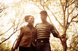 © Mladen - Cheerful African American couple walking trough park and talking.