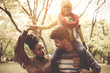 © Mladen - Young African American family in park together.