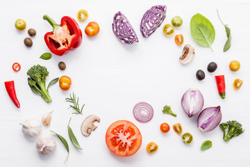 Various fresh vegetables and herbs on white background.Ingredients for cooking concept sweet basil ,tomato ,garlic ,pepper and onion with flat lay..