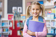 © Rido - Cute school girl holding book