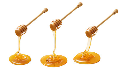 set of wooden dippers with dripping honey isolated on white background