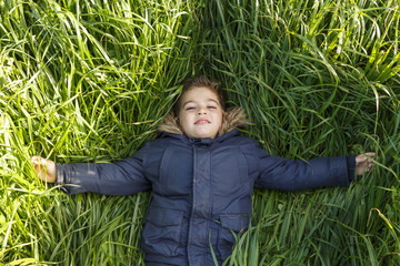 Boy lying on the long grass