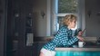 © Wavebreak Media - Woman using mobile phone in kitchen
