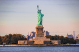 Fototapeta Miasta - Statue of Liberty Sun-kissed by Rays of Warm Light