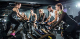 Group of sporty people on cycling class