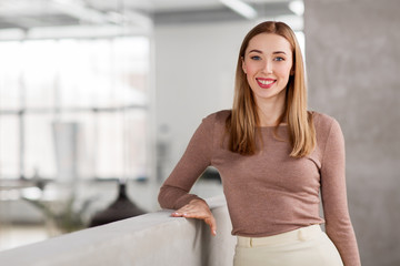 Canvas Print - business, people and corporate concept - happy smiling businesswoman at office