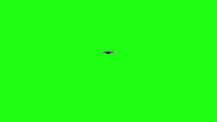 Wall Mural - flying saucer ufo rotates moving over top of green screen. moves over and away from camera into the 