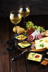 Wall Mural - Delicious traditional Swiss melted raclette cheese on diced boiled or baked potato.