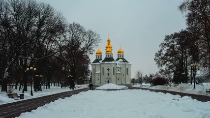 Sticker - Chernihiv, Ukraine. Catherine Church behind the tree branches in winter with white snow at sunset. Time-lapse of a cloudy evening in Chernihiv, Ukraine. Zoom in