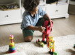 © Rawpixel.com - Black boy playing robot at home