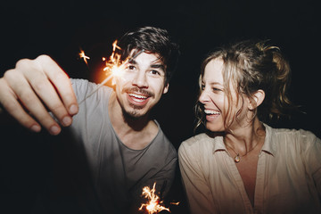 Wall Mural - Friends having fun with sparklers in the night