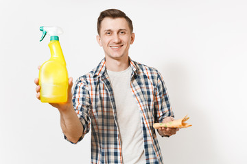 Young housekeeper man holding cleaning rag, white blank empty spray bottle with cleaner liquid isolated on white background. Male doing house chores. Copy space for advertisement. Cleanliness concept.