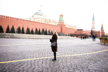 Wall Mural - Portrait in full growth, Russian beautiful woman in a mink coat on the Red Square in Moscow in Christmas time