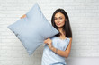 © fotofabrika - Happy smiling woman holding pillow