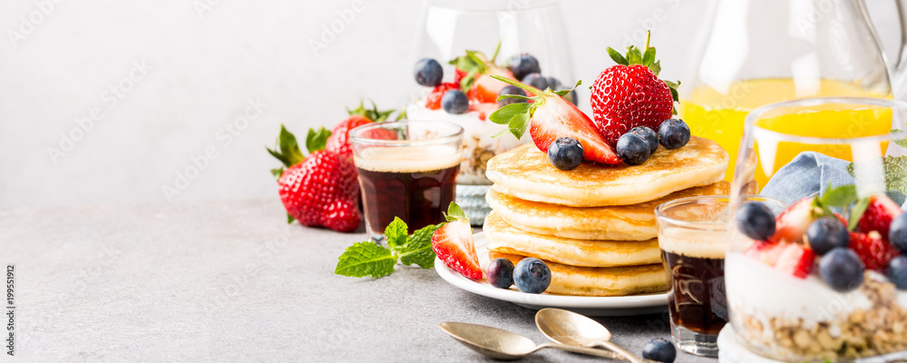Breakfast composition with fresh pancakes and berries on light gray concrete background. Healthy food concept with copy space. Banner. - obrazy, fototapety, plakaty 