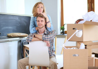 Portrait of young couple moving in new home. Young couple