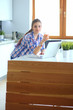 © lenets_tan - Beautiful young smiling female doctor sitting at the desk and writing.