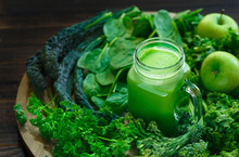 Variety Of Organic Leafy Greens With A Glass Jar Of Fresh Juice