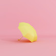 Yellow umbrella on pastel pink background minimal concept. 3d