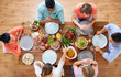© Syda Productions - thanksgiving day, eating and leisure concept - group of people having dinner at table with food