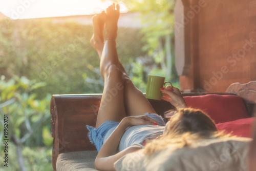 Cuadros en Lienzo Girl enjoying morning coffee on the porch.