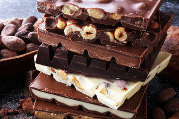 Chocolate bars on dark background with chocolate tower