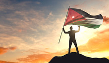 Jordan Flag Being Waved By A Man Celebrating Success At The Top Of A Mountain. 3D Rendering
