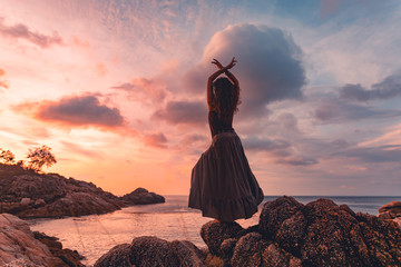 Wall Mural - beautiful young woman silhouette on sunset