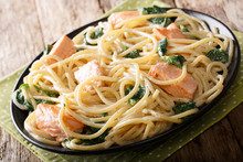 Italian Cuisine: Spaghetti With Salmon, Cream Cheese And Spinach Close-up On Plate. Horizontal