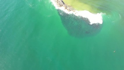 Wall Mural - Trial Bay gaol in Arakoon national park of Australia – aerial lifting from underneath pacific waters to horizon and Gaol castle on a summer sunny day.
