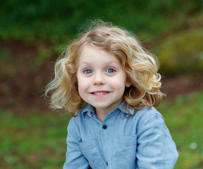 Wall Mural - Happy child with long blond hair enjoying the nature