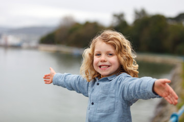 Wall Mural - Happy child with long blond hair enjoying the holidays