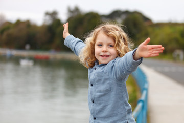 Wall Mural - Happy child with long blond hair enjoying the holidays