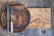 Stainless Steel Cutlery On A Wooden Chopping Board