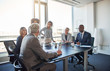 © Flamingo Images - Executives talking business together in an office boardroom