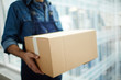 © pressmaster - Relocation service worker or courier carrying packed carton box while distributing it to receiver
