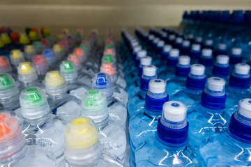 Wall Mural - PET Bottles. Image of many plastic bottles with water in a shop. plastic bottles with drinking water top view. 