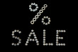 Word sale with sign percent lined with screws letters on black background. Sales creative concept in 3D metal font close-up for hardware store. Mockup for shopping, sales, black friday, copy space.