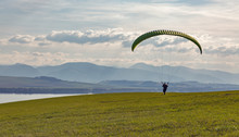 Paraglider Starts Flight From The Hill. Extreme Sports Activity.